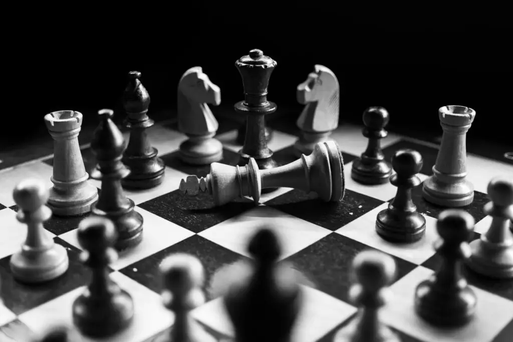 Chessboard with fallen king piece