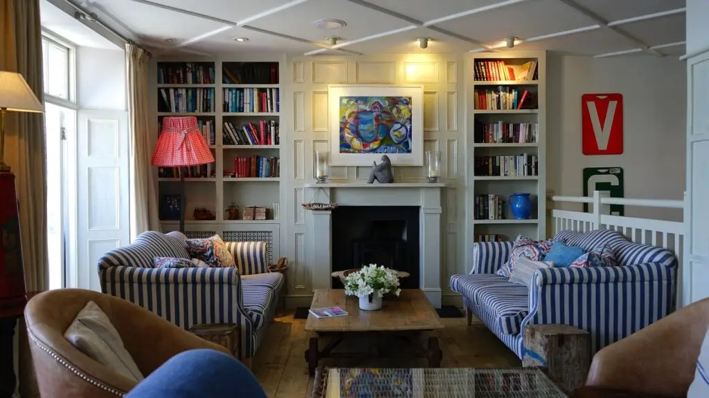 Seating area with coffee table, bookshelf and fireplace